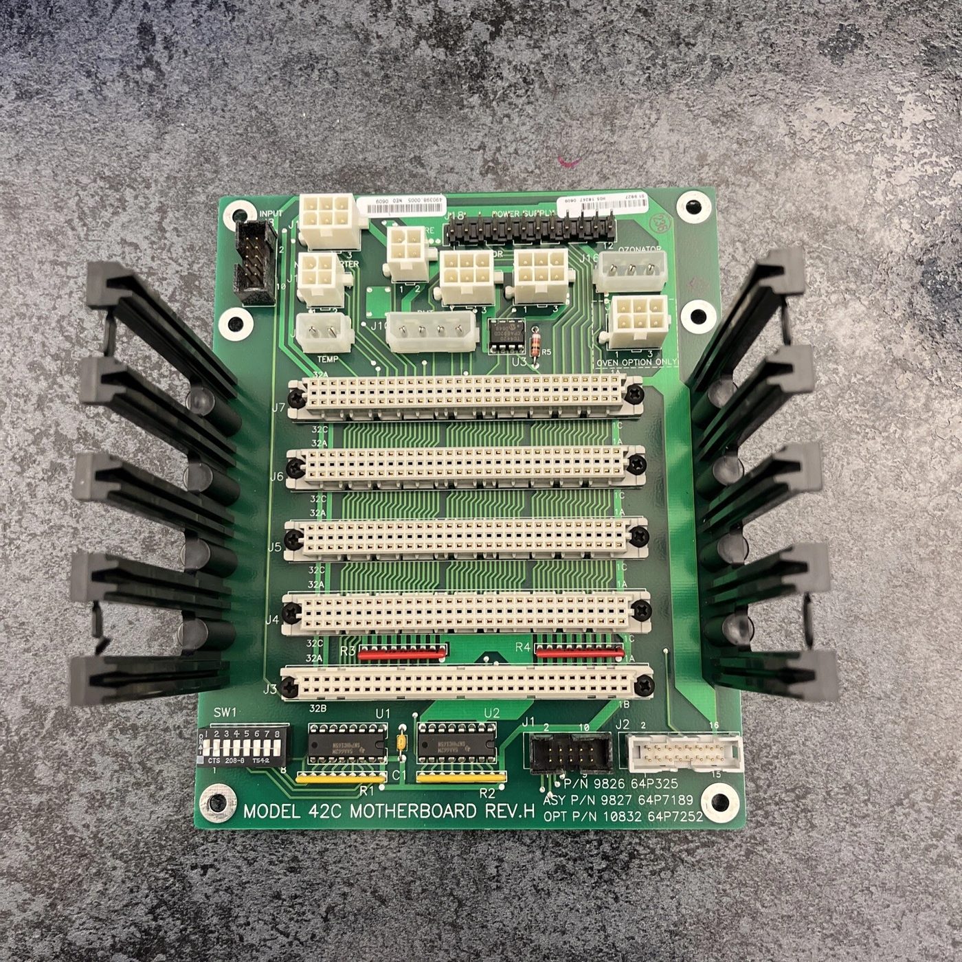 A Thermo Model 42C motherboard, revision H, its green board face covered in ribbon connectors and part-number labels